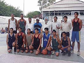 Mr Bachhitter Singh, District Education Officer (Secondary), with the Ludhiana boys (under-17) team for the Punjab Schools Basketball Championship, in Ludhiana on Saturday