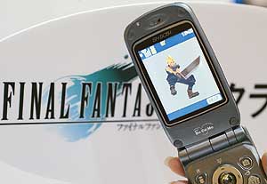 An employee of NTT DoCoMo demonstrates its cellular phone's latest content menu, "Final Fantasy", a role-playing videogame at the Tokyo Game Show 2003 in Chiba, northeast of Tokyo. 