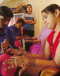 Henna being applied free of cost at a beauty parlour in Kitchlu Nagar, Ludhiana, on Friday.  