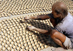 A potter makes diyas in Ambala in preparation for Divali