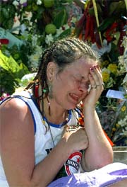 A woman breaks down inside a makeshift memorial to victims of last years blasts in Bali