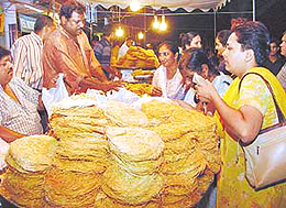 Women busy buying feni on the eve of Karva Chauth in Sector 20, Chandigarh, on Monday.