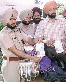 Senior police officers show passports belonging to some of the complainants recovered during a raid from the house of Shamsher Mehandi