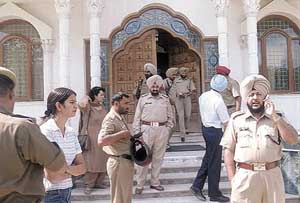 Punjab policemen outside the Nihal Vihar (West Delhi) farmhouse of Punjabi singer Daler Mehndi during a raid in the Capital on Tuesday.