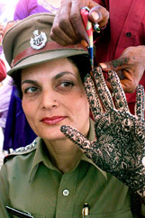 A policewoman gets mehndi imprint on her hand on the occasion of Karva Chauth in Jammu