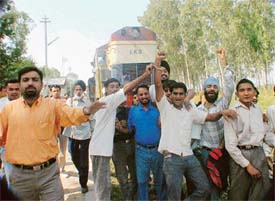 Passengers block the Ferozepore-Ludhiana train at Baddowal railway station 