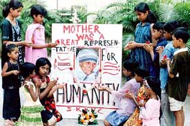 Children decorate a portrait of Mother Teresa in Kolkata on Tuesday ahead to Mother's beatification in Vatican on October 19