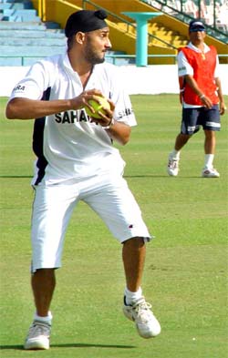 Harbhajan Singh prepares to throw a ball during a practice session at PCA Stadium in Mohali 