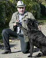 Roland T. of Germany demonstrates the stiff-arm Hitler salute trick of his German shepherd crossbreed dog named Adolf to a photographer in Berlin 