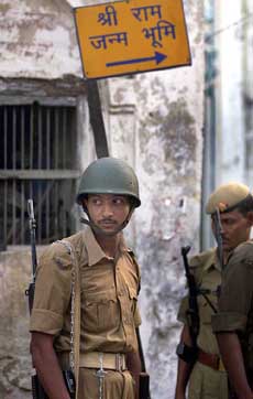 Policemen stand guard at a disputed site in Ayodhya 