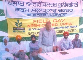 Mr B.K. Chopra, Senior Manager, NFL, addresses farmers at Dharamgarh village