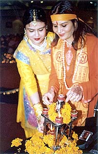 Members of the Sarabha Ladies Club light lamps at a function organised as part of Divali celebrations in Ludhiana