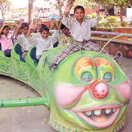 Slum children take a free ride on World Food Day at Appu Ghar in the Capital