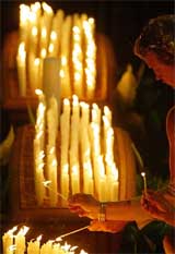 Relatives of the Bali bombing victims light candles during the National Remembrance Service at Parliament House in Canberra