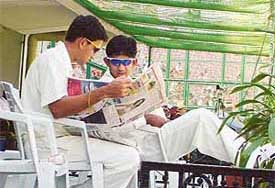 Ajit Agarkar and Sairaj Bahutule take a look at a copy of Chandigarh Tribune
