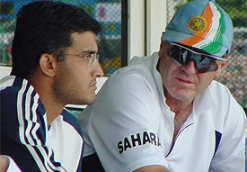 Worried Indian coach John Wright (R) watches the proceedings with Sourav Ganguly on the second day of the second Test against New Zealand at PCA Stadium, Mohali.  A Tribune photo
