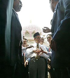 Malaysian Prime Minister Mahathir Mohamad meets fellow Muslims after Friday prayer in Putrajaya near Kuala Lumpur. The British government has called in Malaysia's top diplomat in London to complain over comments about Jews Mahathir made at an Islamic summit in Malaysia.