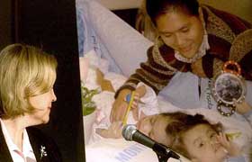 Dr Joelle Mast looks at a picture of conjoined twins