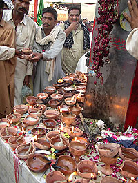 Pakistani devotees light oil lamps at the shrine of Muslim saint Shehbaz Qalander in Sehwan Sharif, 200 km north of Karachi, on Friday. Thousands of devotees turn up every year to pay homage to the 13th century Muslim saint.