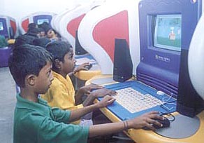 Children trying their hand at the IBM Kidsmart Early Learning Programme.