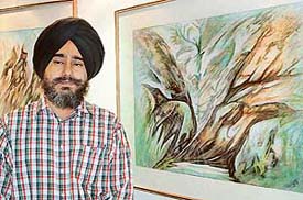 Satwant Singh Sumail with his creations on display at the Indusind Art Gallery in Chandigarh on Monday 