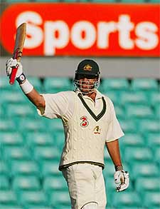 Australia's Matthew Hayden raises his bat after reaching his century
