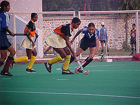 An Orissa player is tackled by a Haryana player in a league match of the 29th National Womens Sports Festival