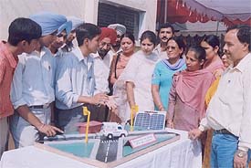 A student explains his model on automated bypass for ambulances and VIP vehicles during an inter-school science model competition at Government Model Senior Secondary School
