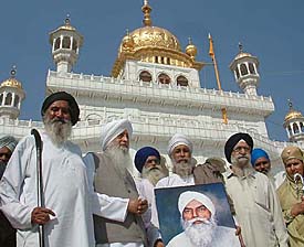 President of Khalsa Raj Party Jagjit Singh Chohan and his supporters carry a portrait of Darshan Singh Pheruman after performing ardas at Akal Takht 