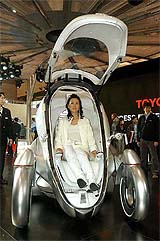 A model rides on a Toyota Motor Corp new concept car PM during the 37th Tokyo Motor Show