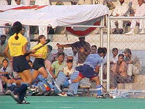 Chandigarhs Raj Rani makes her way into the rival goal as Punjab defenders watch her during their final match at the National Womens Sports Festival
