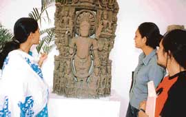 A museologist (left) makes a point to students. 
