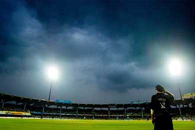 New Zealand's Coyle Mills watches rain clouds gather over Chidambaram stadium