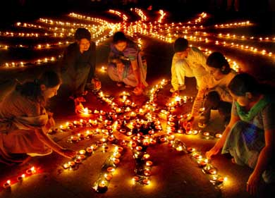 People light diyas on the eve of Divali in Sector 17