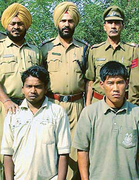 The two persons suspected of drugging and looting train passengers  in the custody of the Railway Police in Chandigarh on Monday.