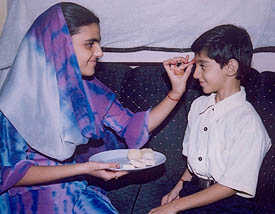 A sister applies ‘tilak’ on the forehead of her brother on Bhaiya Dooj