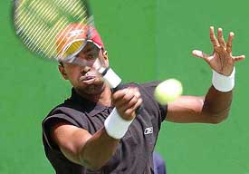 Prakash Amritraj returns the ball against Sunday Maku of Nigeria during the mens singles team final match 