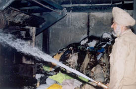 A fireman tries to douse flames in a dyeing factory in Industrial Area A, Ludhiana, where a major fire broke out