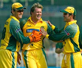 Australias Brad Williams celebrates with Adam Gilchrist and Damien Martyn after taking the wicket of New Zealands Scott Styris in the third one-day match