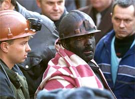 A rescued miner is led out of a mine in Russias southern town of Novoshakhtinsk 
