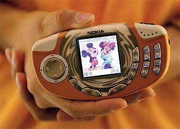 A message featuring Mickey Mouse and Minnie Mouse is displayed on a mobile phone at a ceremony to launch the Chinese Disney Online services