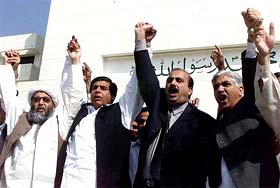 Pakistans Opposition lawmakers chant anti-government slogans during a protest against the arrest of one of their key leaders in front of Parliament House in Islamabad
