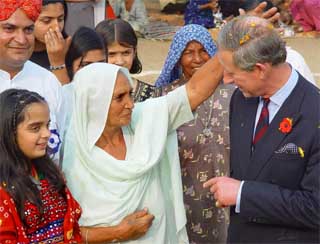 An old woman blesses Prince Charles 