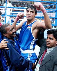 Akhil Kumar is mobbed by supporters after his victory in the final of the light flyweight 48-51 kg boxing event