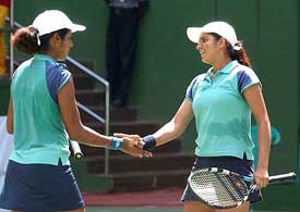 Sania Mirza and Rusmi Chakravarthy shake hands after winning the womens doubles final against Stefanie Rosa Maya and Septi Mende of Indonesia