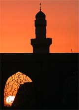 The sun sets over the sacred Shi'ite mosque of Imam Ali in the desert near Basra