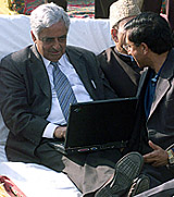 Chief Minister Mufti Mohammed Sayeed uses a laptop at the launch of the "world's first Wi-Fi (Wireless Fidelity)-enabled lake" in Dal Lake, Srinagar