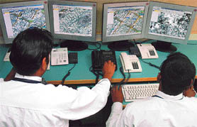 Pakistani operators work at a car-tracking station in Karachi. With the click of a computer mouse, a satellite tracking system allows remote operators to seize control of the stolen vehicle, bring it to a grinding halt and snap its locks shut.