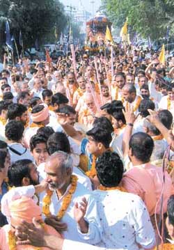 Devotees dancing and chanting to the tunes of "Hare Rama, Hare Krishana" all along the procession route