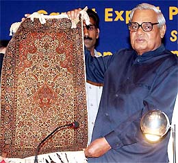 Prime Minister Atal Bihari Vajpayee holds a small carpet at the inauguration of the 1st World Conference on handmade carpets in New Delhi